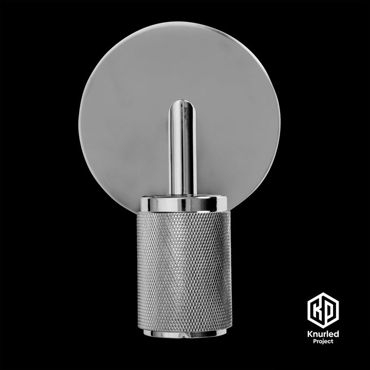 Chrome wall light front on with a black background